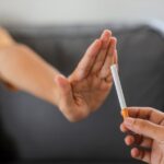 Close up hand is refusing cigarette offer. Quit smoking concept.