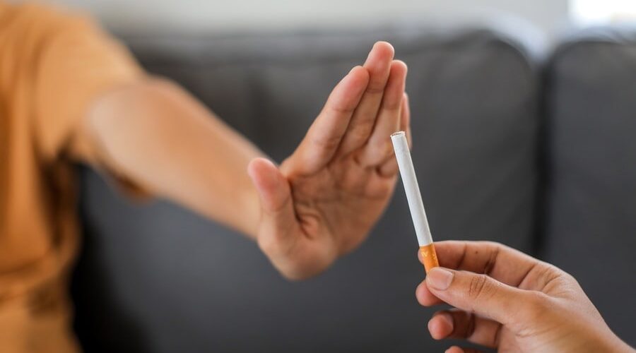 Close up hand is refusing cigarette offer. Quit smoking concept.