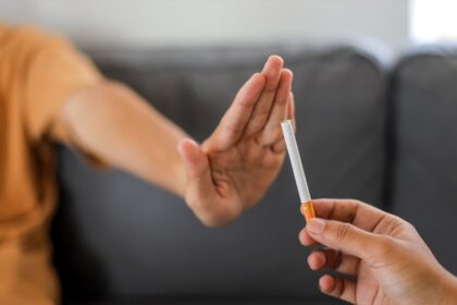 Close up hand is refusing cigarette offer. Quit smoking concept.